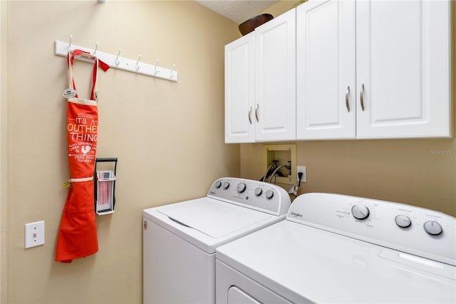 laundry area with washing machine and dryer and cabinet space