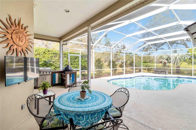 outdoor pool featuring a patio area, glass enclosure, and a grill