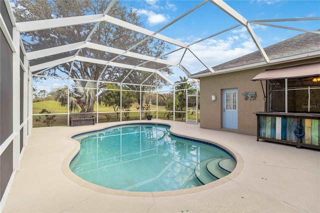 outdoor pool with a patio area and a lanai