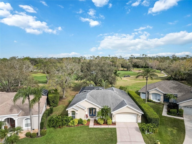 view of subject property featuring a golf course and a tree filled landscape