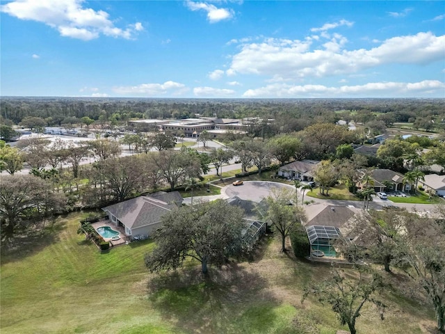 view of property location with nearby suburban area and a pool area