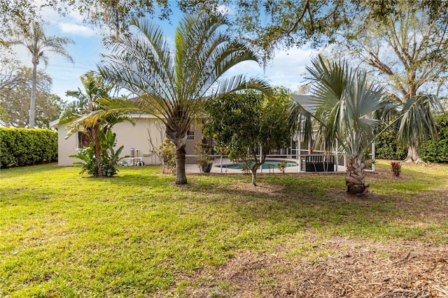 view of green lawn with an outdoor pool