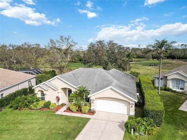 view of front of property with stucco siding, an attached garage, concrete driveway, and a front yard