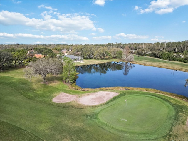 aerial overview of property's location with a nearby body of water, a golf club, and a tree filled landscape