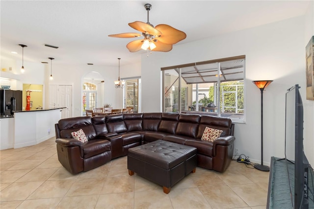 10306 Palmbrooke Ter, Bradenton, FL 34202 - living room with ceiling fan, light tile patterned flooring, arched walkways, and baseboards