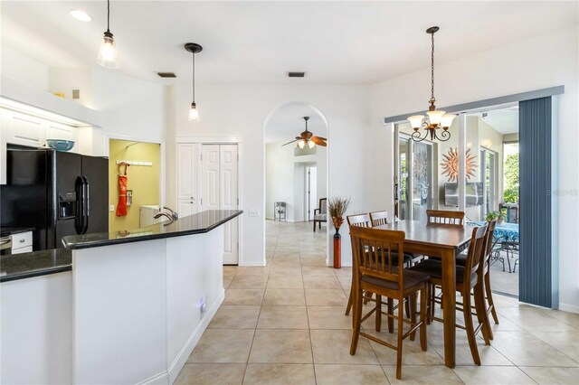 10306 Palmbrooke Ter, Bradenton, FL 34202 - dining area featuring ceiling fan, light tile patterned floors, a chandelier, and baseboards