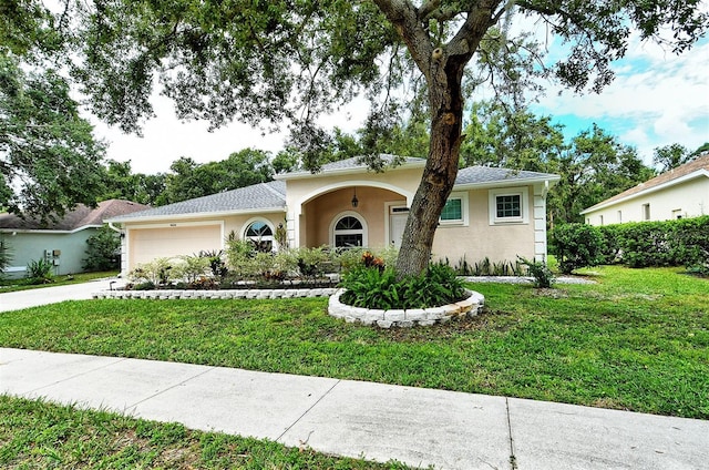 single story home featuring a garage, driveway, a front lawn, and stucco siding