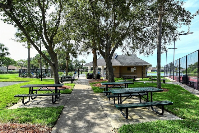 surrounding community with a lawn and fence