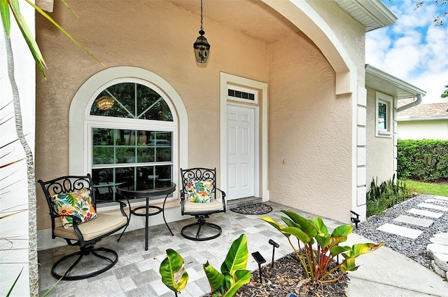 property entrance featuring stucco siding