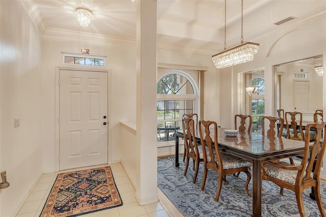 dining area featuring light tile patterned floors, visible vents, an inviting chandelier, ornamental molding, and baseboards