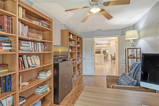 office area with light wood-type flooring, ceiling fan, and visible vents