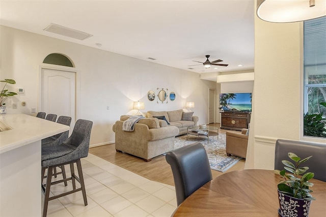 living area featuring a ceiling fan and visible vents