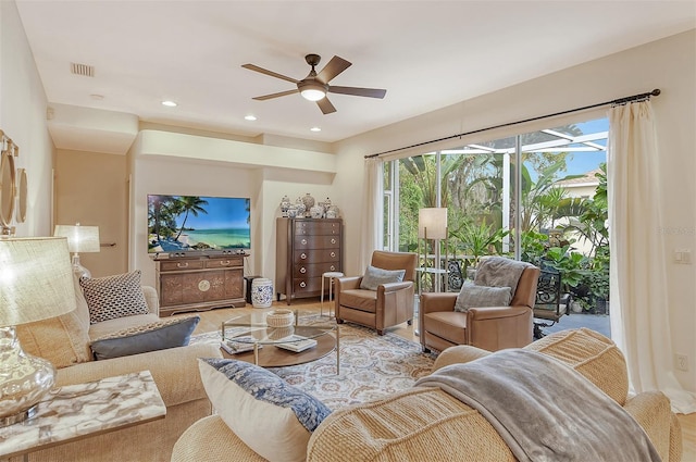 living area with visible vents, a ceiling fan, and recessed lighting