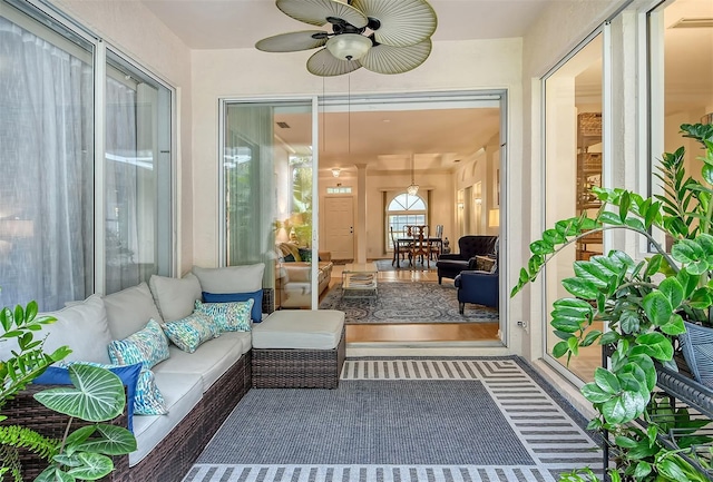 sunroom / solarium with ceiling fan and visible vents