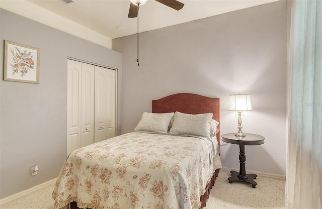 bedroom with carpet floors, a closet, baseboards, and a ceiling fan