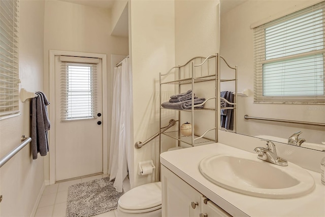 bathroom featuring toilet, tile patterned floors, vanity, baseboards, and a shower with curtain