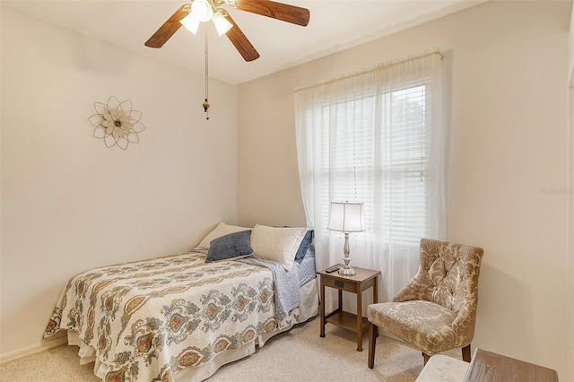 bedroom featuring baseboards, a ceiling fan, and light colored carpet