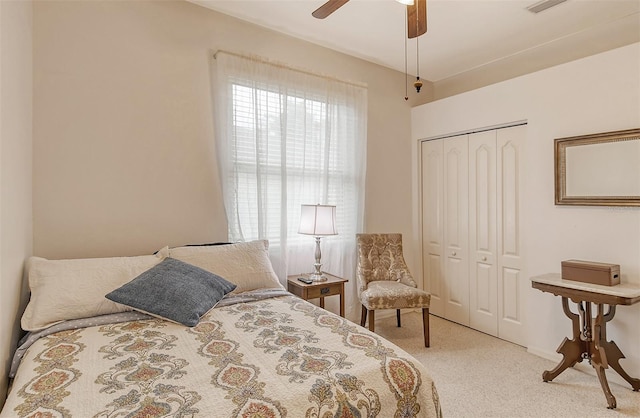 bedroom with carpet, ceiling fan, and a closet