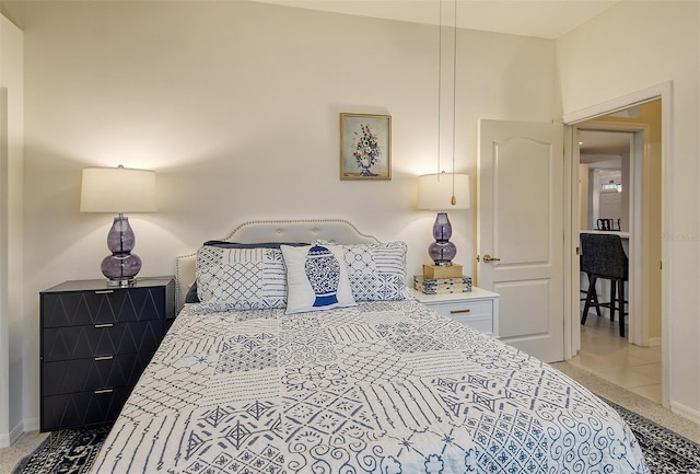 bedroom with baseboards and light colored carpet