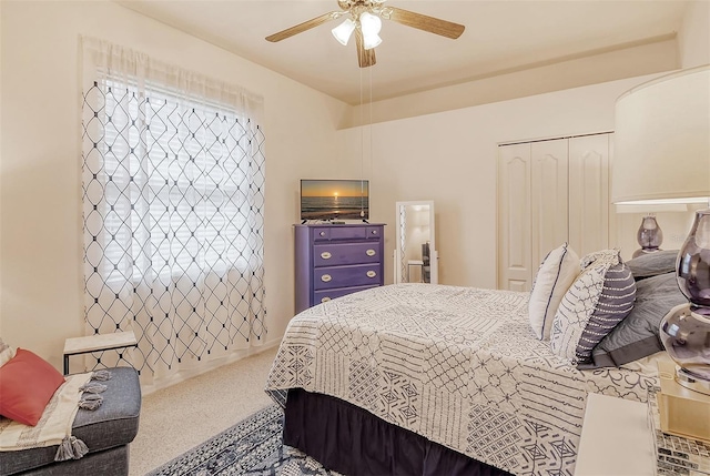 bedroom with ceiling fan, a closet, and carpet flooring