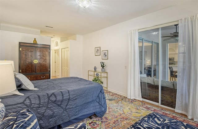 bedroom with access to outside, visible vents, and baseboards