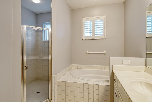 bathroom featuring a stall shower, a wealth of natural light, vanity, and a bath