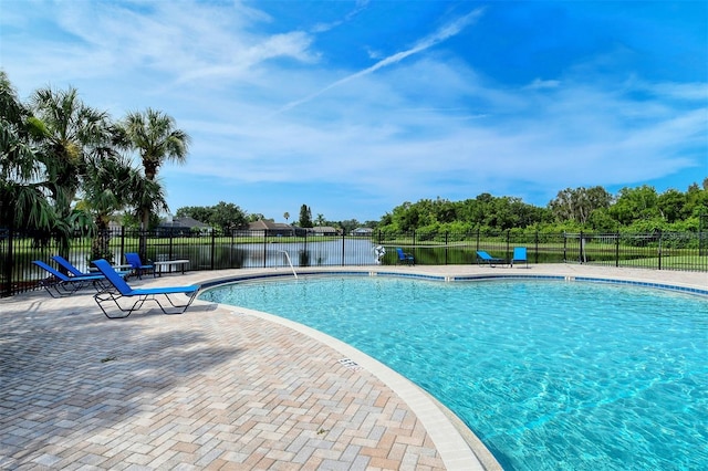 community pool featuring a patio area and fence