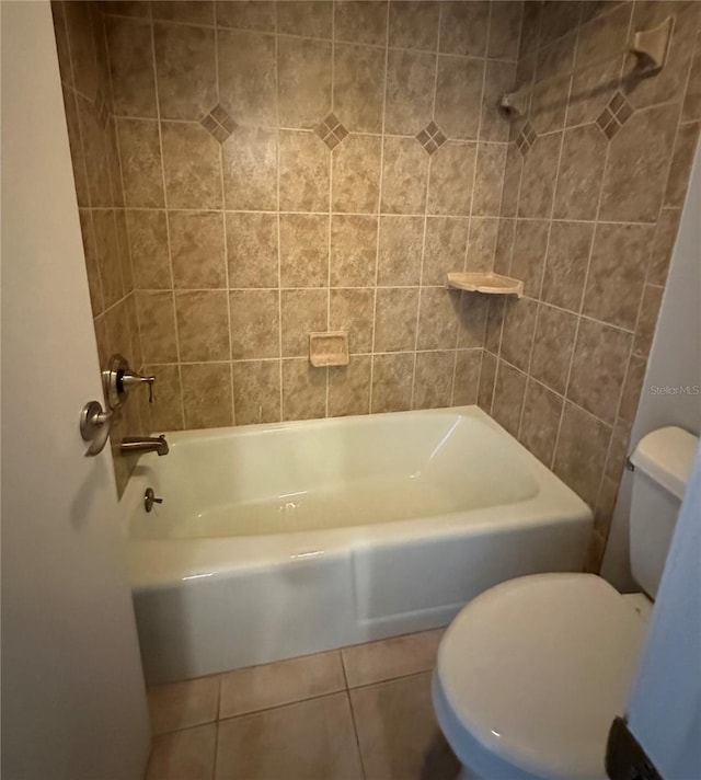 full bathroom featuring toilet, tile patterned flooring, and shower / bathing tub combination