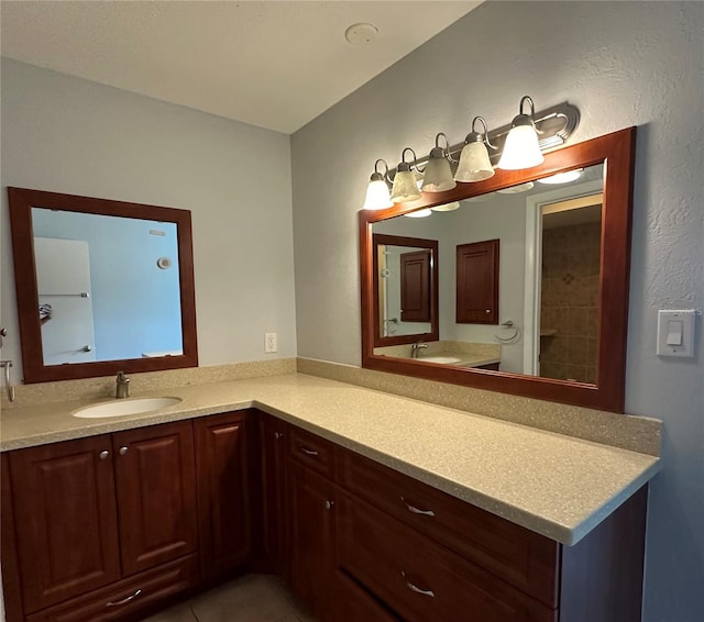 bathroom with tile patterned flooring and vanity