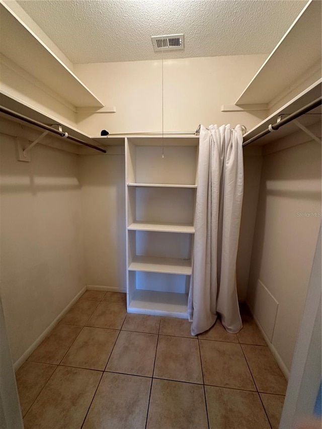 spacious closet with tile patterned flooring and visible vents