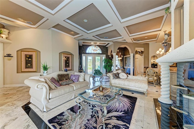 living area featuring arched walkways, coffered ceiling, a towering ceiling, visible vents, and baseboards