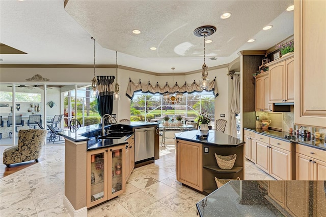 kitchen featuring hanging light fixtures, stainless steel dishwasher, glass insert cabinets, a sink, and an island with sink