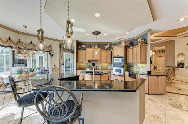 kitchen featuring stainless steel appliances, tasteful backsplash, a center island with sink, and ornamental molding