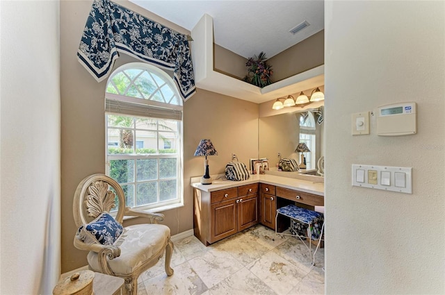 bathroom with visible vents, vanity, and baseboards