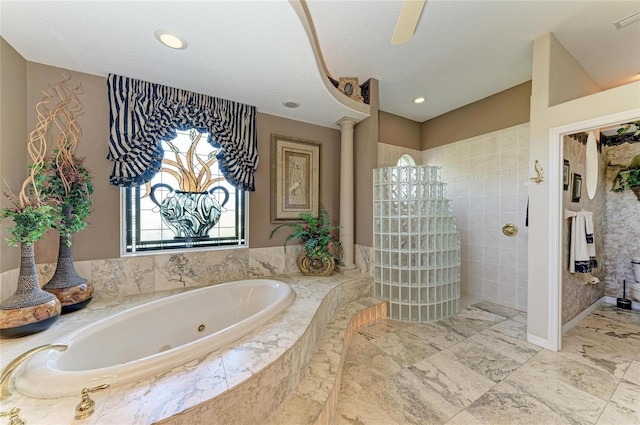 bathroom featuring a tub with jets and a walk in shower