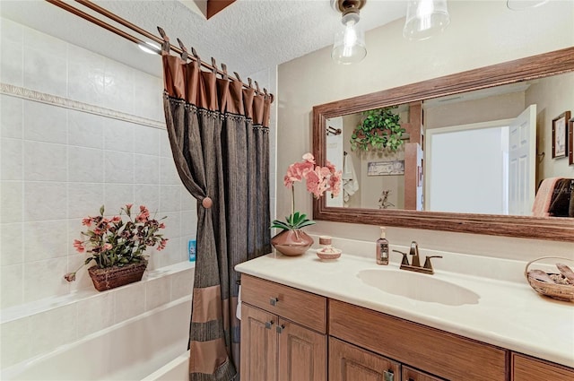 bathroom featuring a textured ceiling, shower / bath combo, and vanity