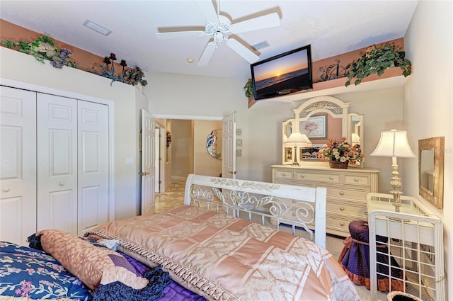 bedroom with a closet, visible vents, and ceiling fan