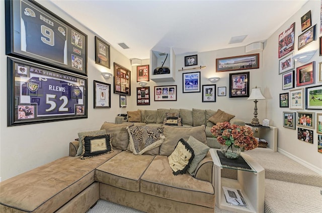 carpeted home theater featuring visible vents and baseboards