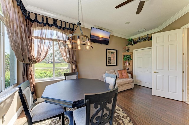 dining room with ornamental molding, dark wood-style flooring, and a ceiling fan