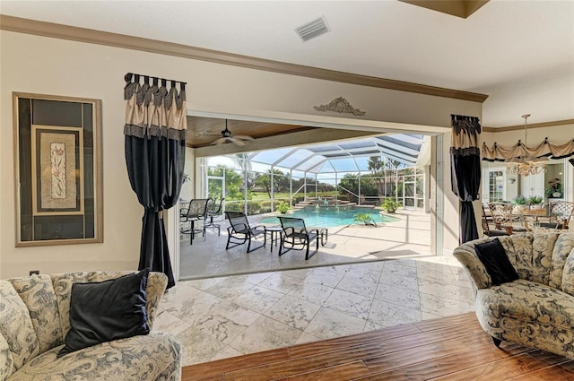 living room featuring a sunroom, visible vents, and crown molding