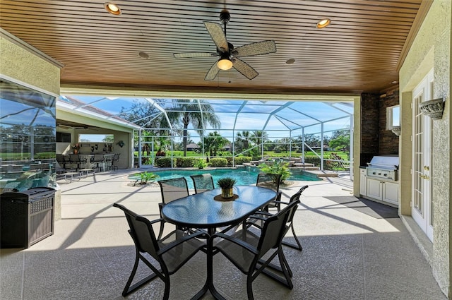 view of patio with a pool with connected hot tub, a lanai, a grill, and exterior bar