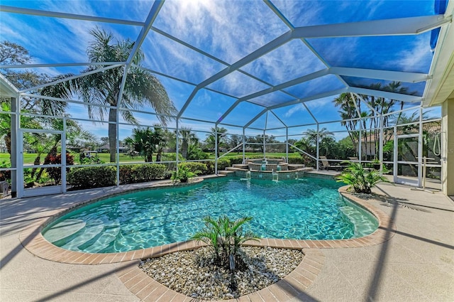 view of pool featuring glass enclosure, a patio, and a pool with connected hot tub