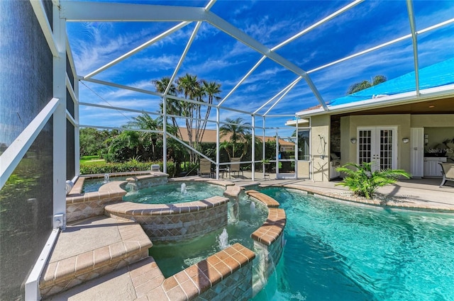 view of swimming pool featuring a lanai, a patio area, a pool with connected hot tub, and french doors