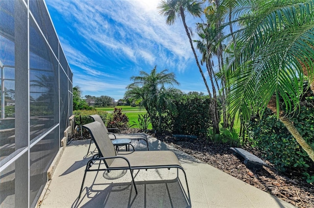 view of patio with glass enclosure