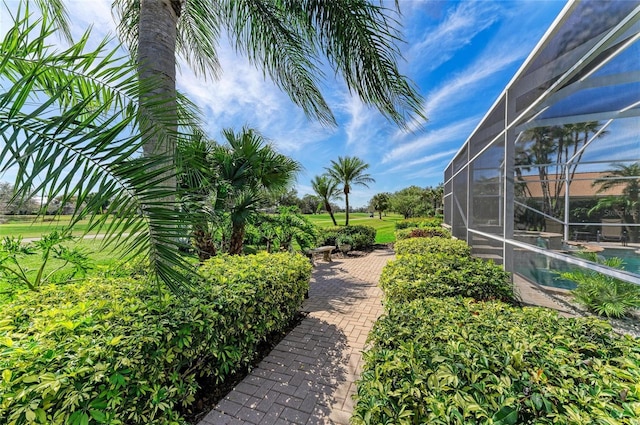 view of yard featuring glass enclosure