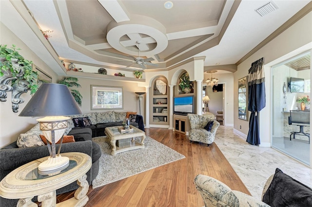 living room with arched walkways, visible vents, ornamental molding, coffered ceiling, and baseboards