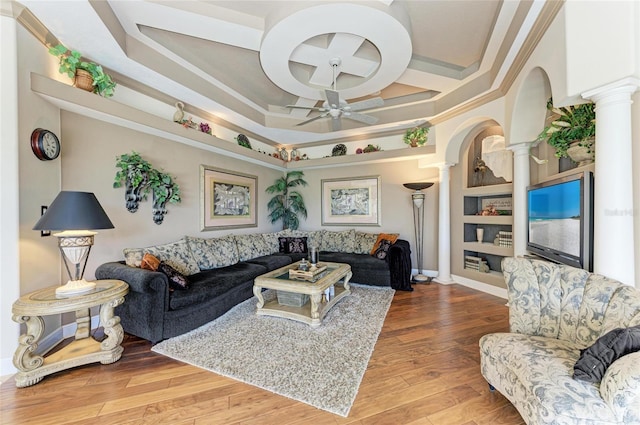 living area with arched walkways, coffered ceiling, wood finished floors, and ornate columns