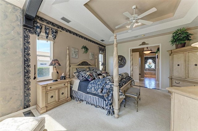 10002 Cherry Hills Avenue Cir, Bradenton, FL 34202 - bedroom featuring a tray ceiling, light colored carpet, a ceiling fan, and baseboards