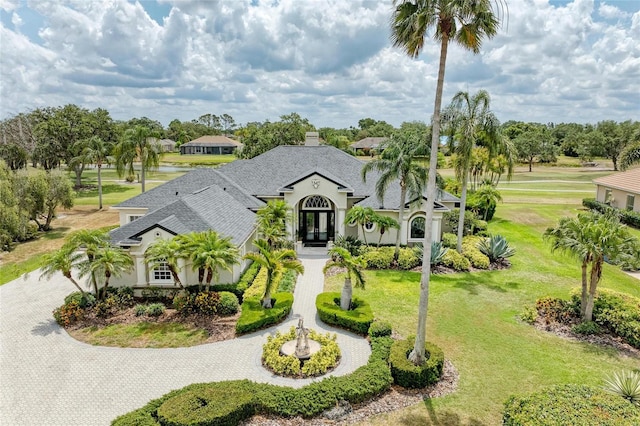 10002 Cherry Hills Avenue Cir, Bradenton, FL 34202 - view of front of property with curved driveway, a front lawn, roof with shingles, and stucco siding