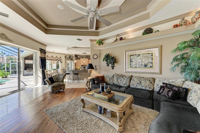 10002 Cherry Hills Avenue Cir, Bradenton, FL 34202 - living area featuring a ceiling fan, a tray ceiling, hardwood / wood-style floors, crown molding, and recessed lighting